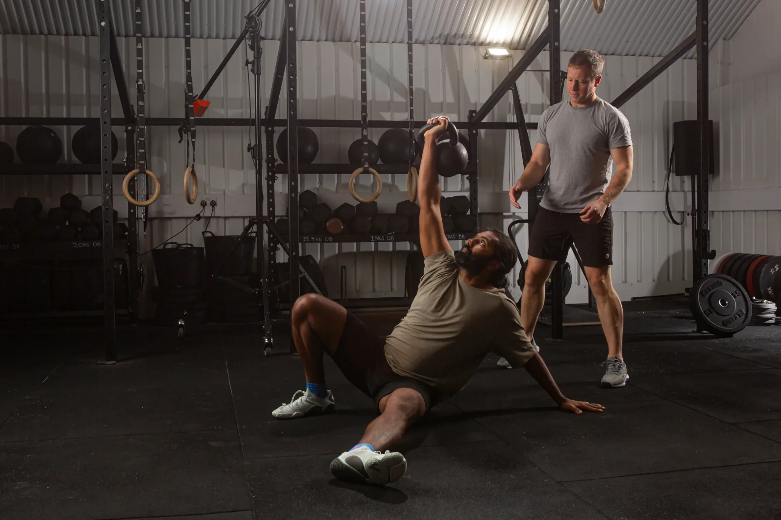 Stuart Frew coaching a client through a Turkish get-up at Basis Gym, London Fields